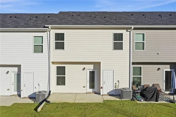 a view of a house with backyard sitting area and garden