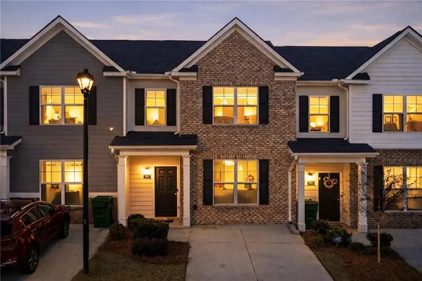 a view of a brick house with large windows