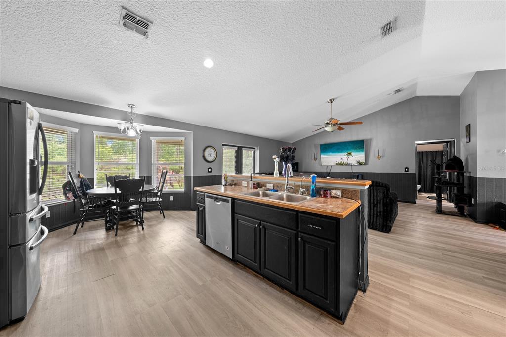 1965 Mustang Court St. Cloud, FL 34771 - Photo 14 of 33 a large kitchen with a stove and wooden floor