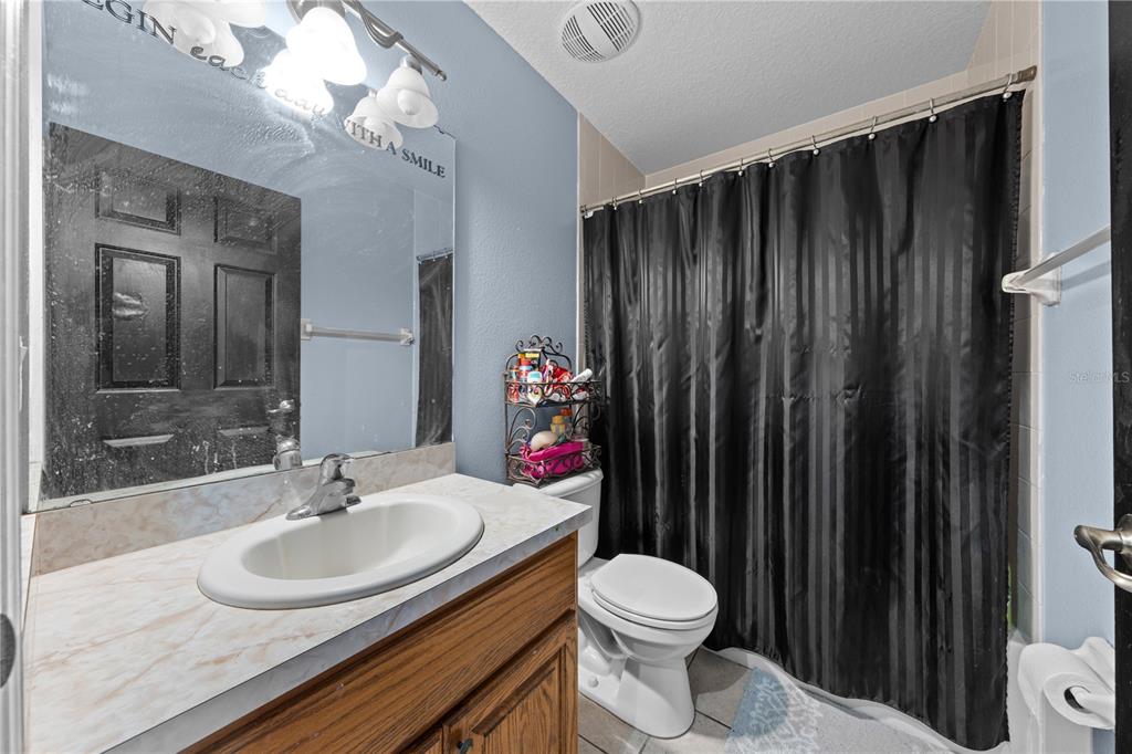 1965 Mustang Court St. Cloud, FL 34771 - Photo 21 of 33 a bathroom with a sink toilet and shower
