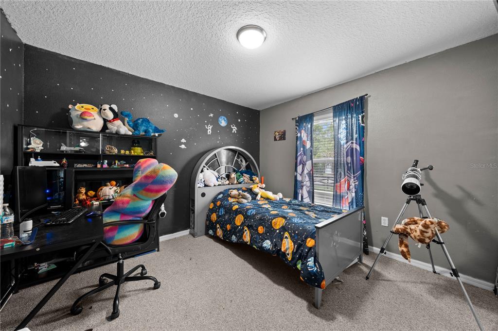 1965 Mustang Court St. Cloud, FL 34771 - Photo 22 of 33 a bedroom with bed and a window