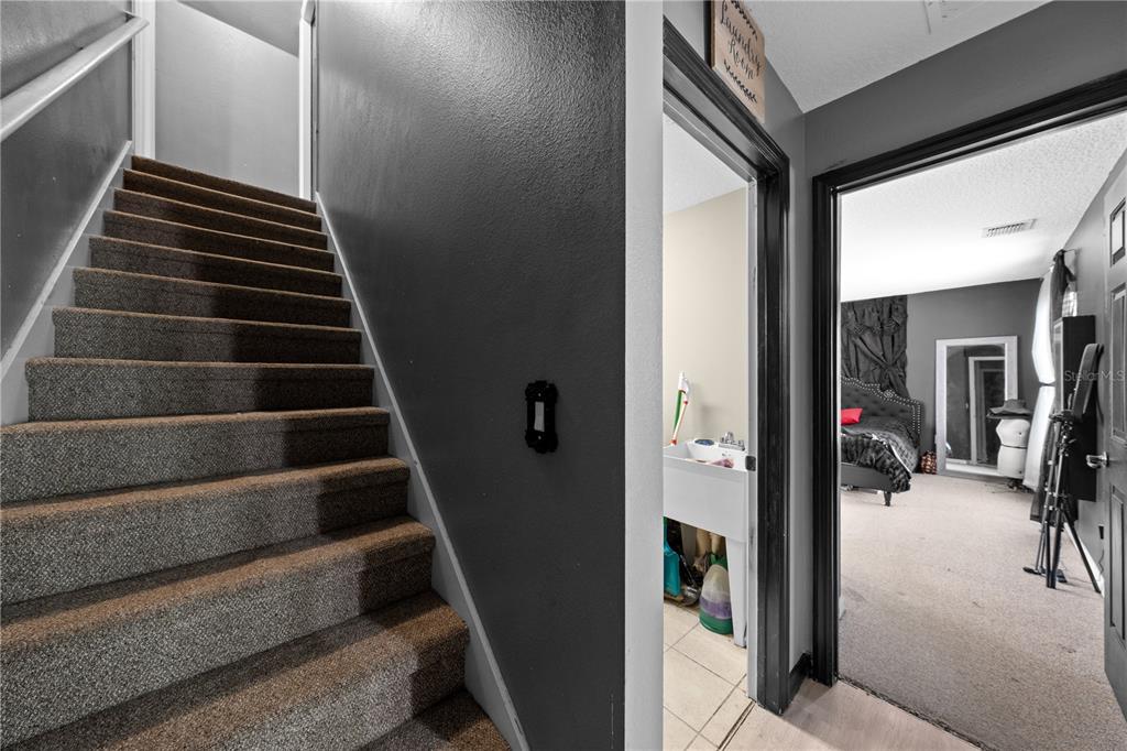 1965 Mustang Court St. Cloud, FL 34771 - Photo 23 of 33 a view of hallway with stairs and wooden floor