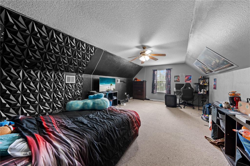 1965 Mustang Court St. Cloud, FL 34771 - Photo 24 of 33 a bed room with a bed window and a chair
