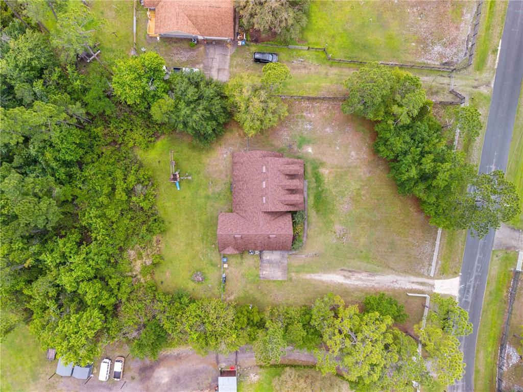 1965 Mustang Court St. Cloud, FL 34771 - Photo 28 of 33 an aerial view of a house with a yard