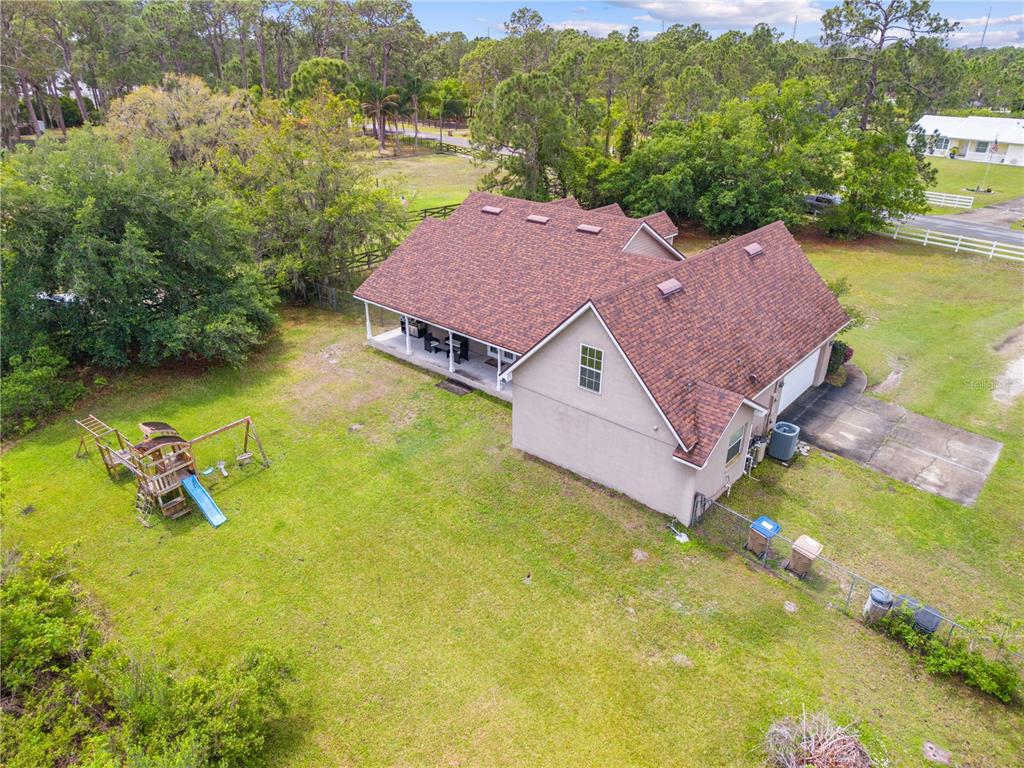 1965 Mustang Court St. Cloud, FL 34771 - Photo 32 of 33 an aerial view of a house with swimming pool and mountains
