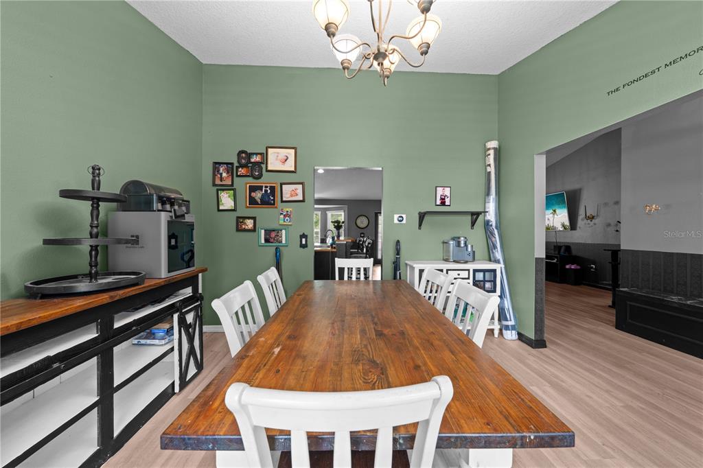 1965 Mustang Court St. Cloud, FL 34771 - Photo 7 of 33 a view of a dining room with furniture and wooden floor