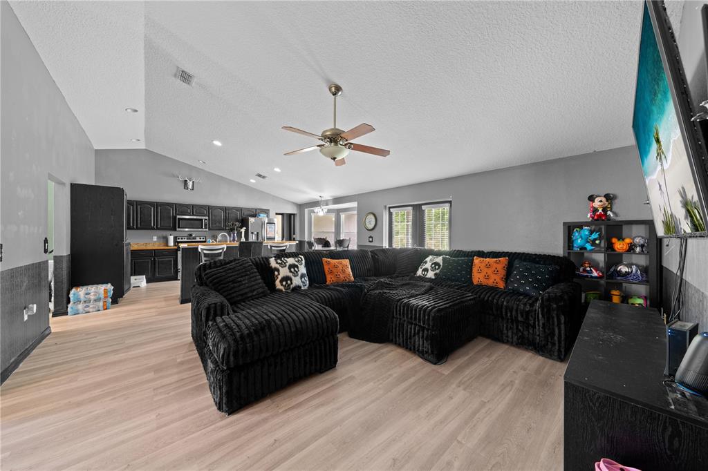 1965 Mustang Court St. Cloud, FL 34771 - Photo 9 of 33 a living room with furniture and a flat screen tv