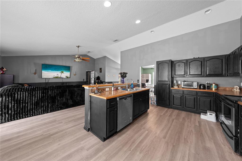 1965 Mustang Court St. Cloud, FL 34771 - Photo 10 of 33 a kitchen with stainless steel appliances granite countertop a stove a sink dishwasher and a refrigerator