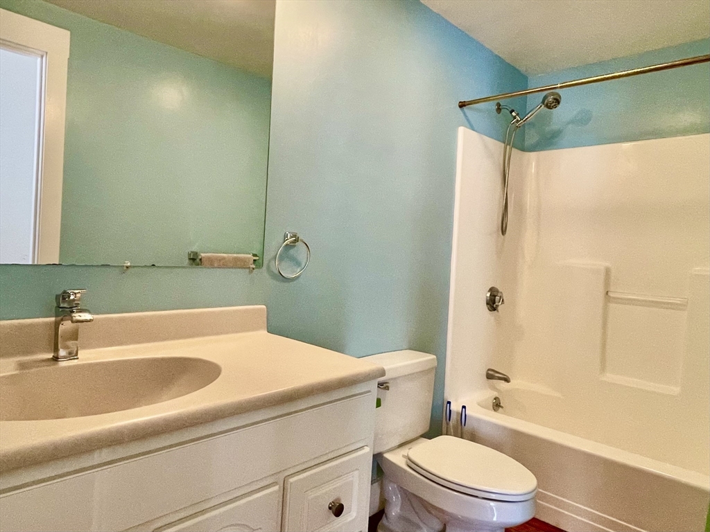 49 Munroe Street, Unit 201 Lynn, MA 01901 - Photo 11 of 14 a bathroom with a sink a toilet and shower