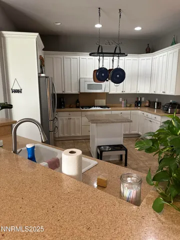 a kitchen with stainless steel appliances granite countertop a sink a stove and a refrigerator