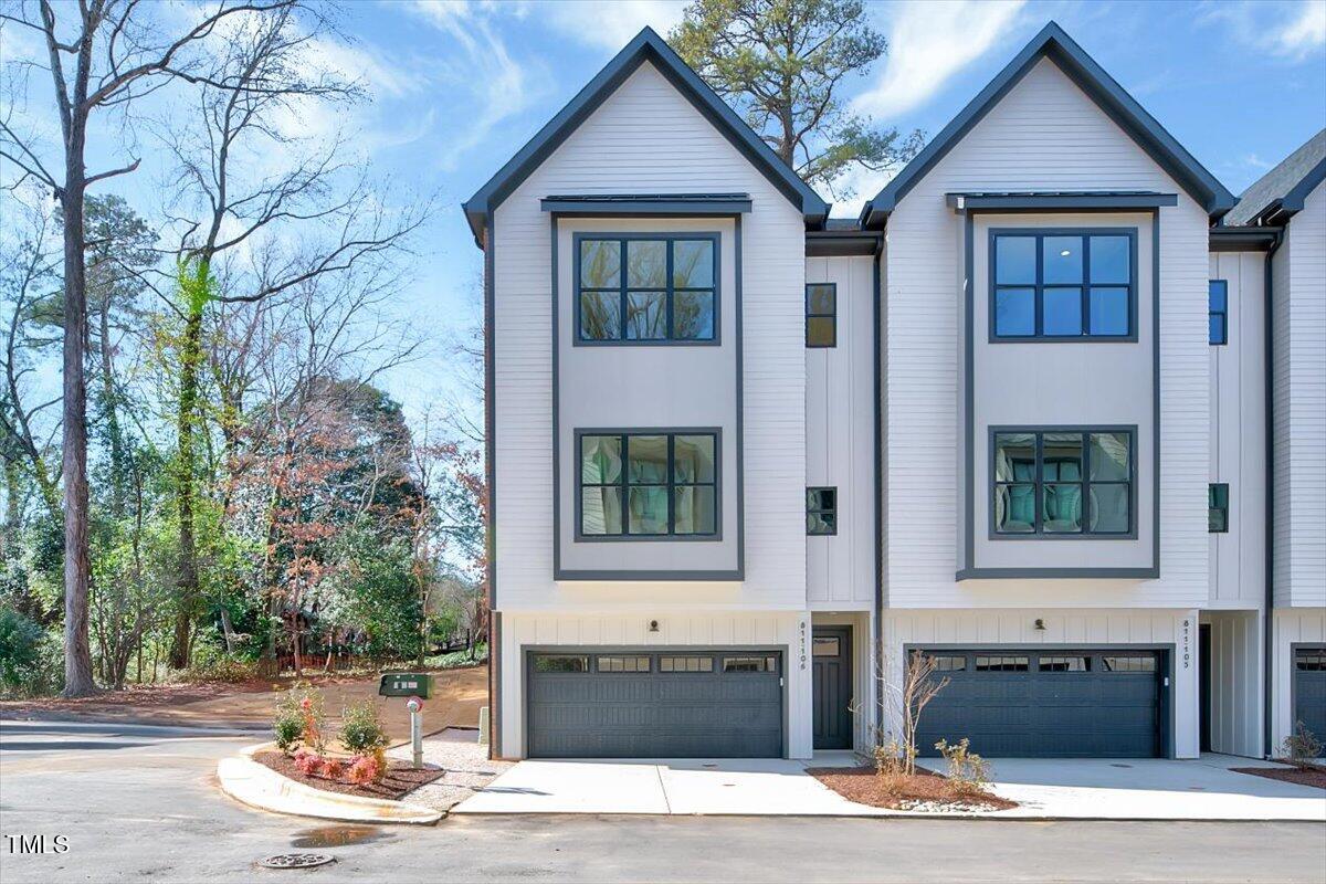 811 Maple Berry Lane, Unit 106 Raleigh, NC 27607 - Photo 1 of 30 a front view of a house with a yard