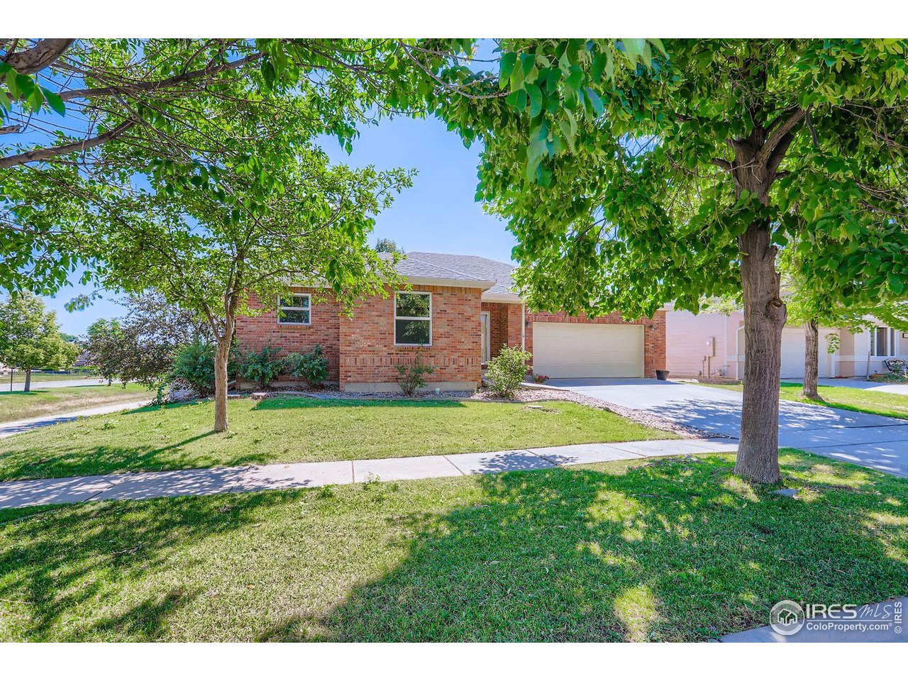 a view of a house with a yard and tree