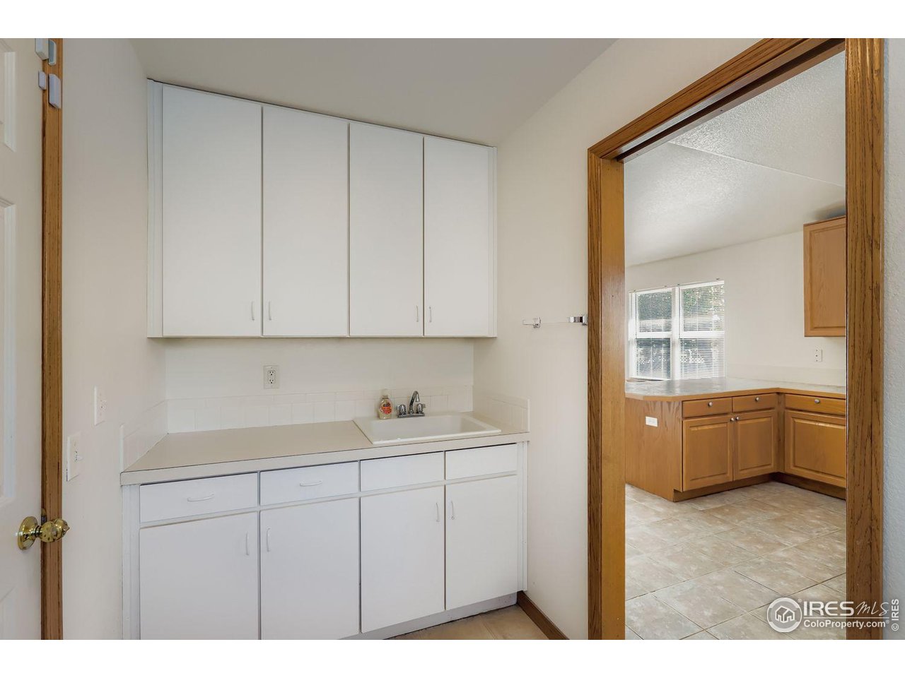 310 Bein Street Berthoud, CO 80513 - Photo 12 of 31 a kitchen with a sink cabinets and window