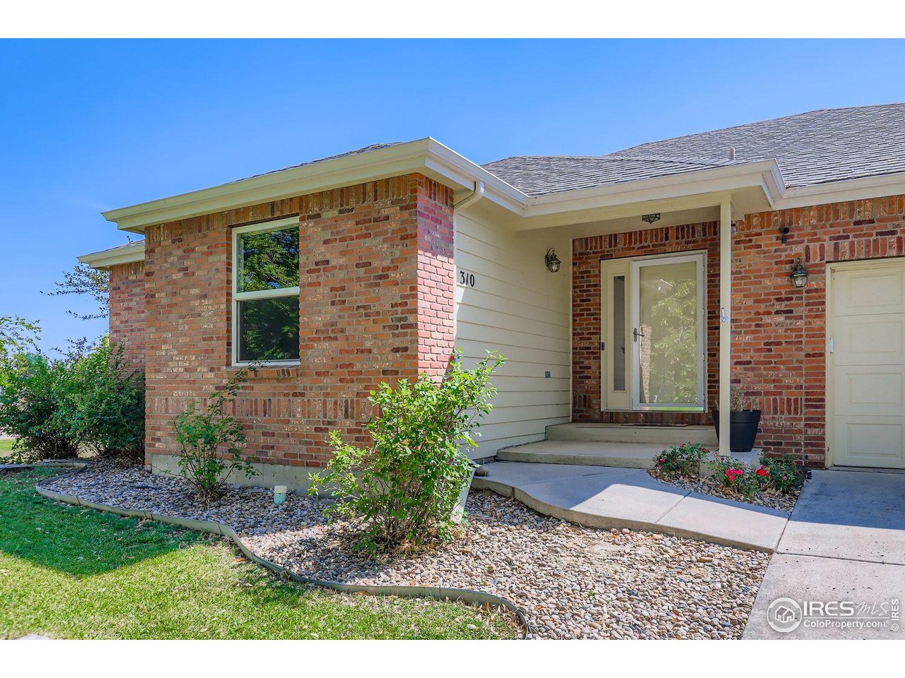 310 Bein Street Berthoud, CO 80513 - Photo 2 of 31 a view of a house with brick walls
