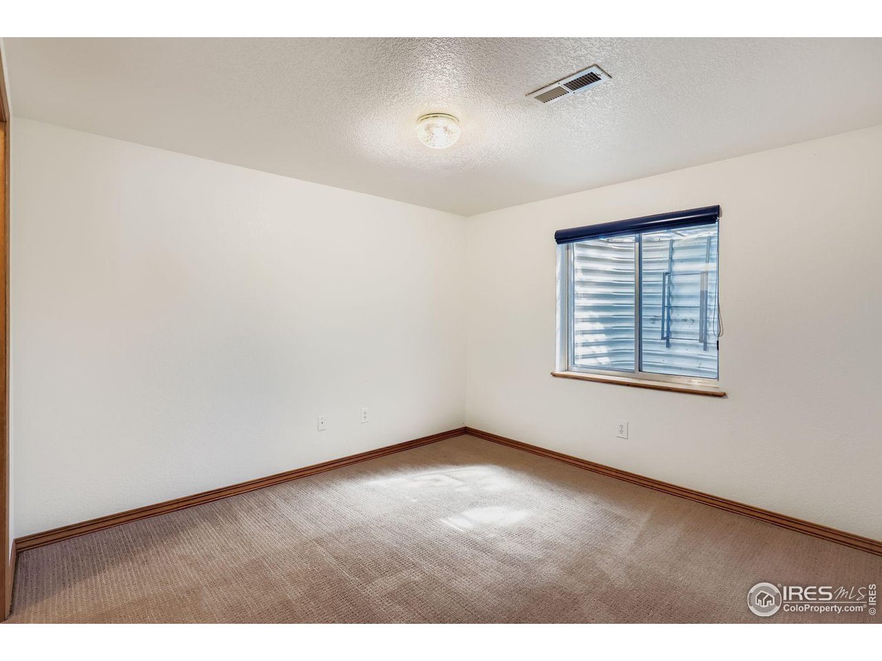 310 Bein Street Berthoud, CO 80513 - Photo 23 of 31 a view of an empty room with a window