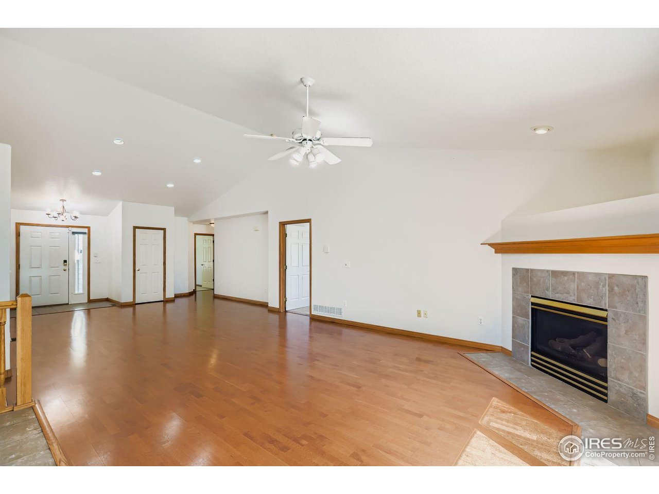 310 Bein Street Berthoud, CO 80513 - Photo 4 of 31 a view of an empty room with kitchen view and a fireplace