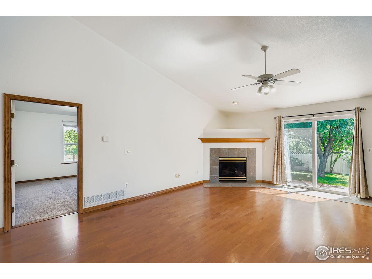 310 Bein Street Berthoud, CO 80513 - Photo 5 of 31 a view of an empty room with a fireplace and a window