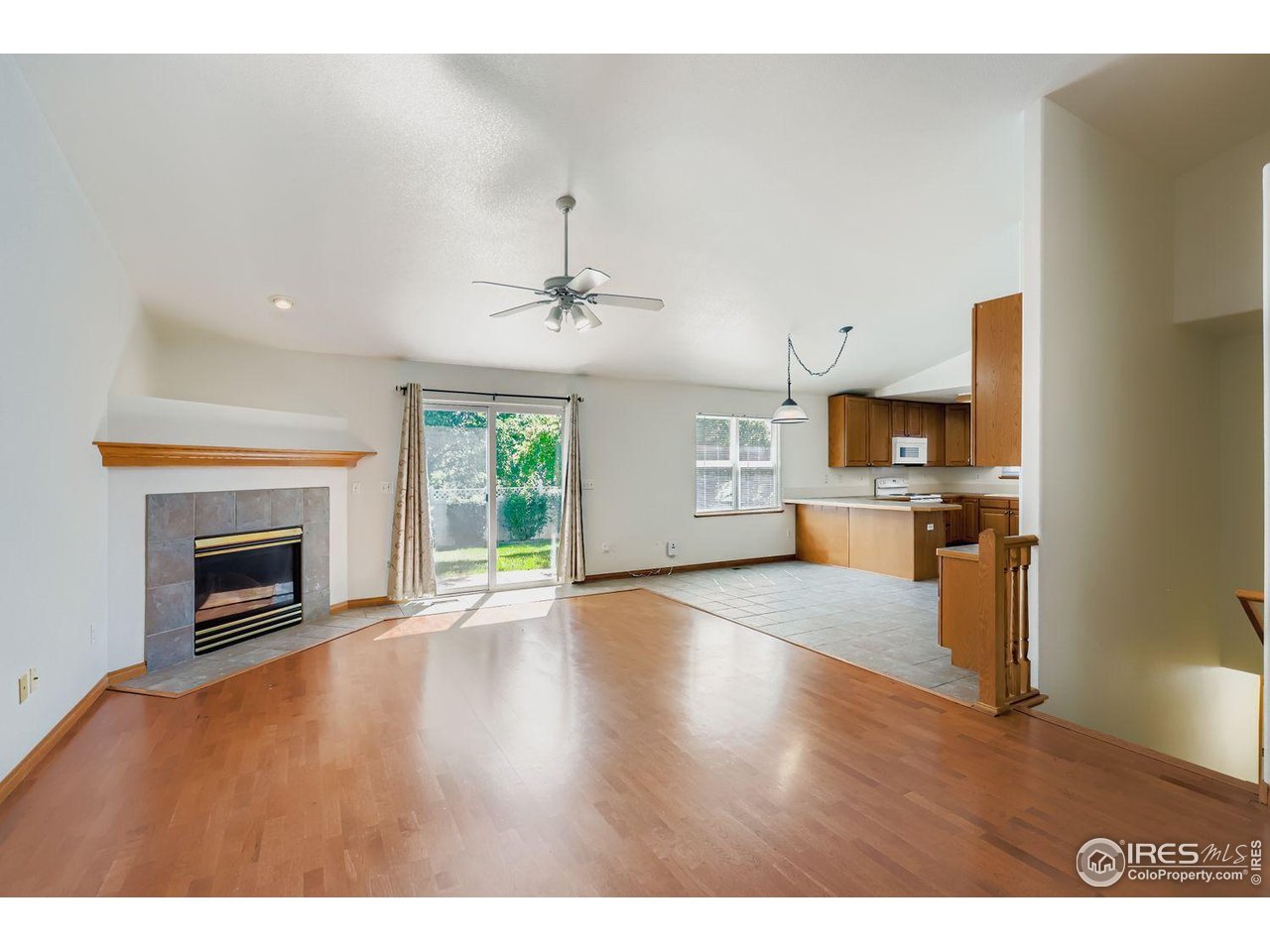 310 Bein Street Berthoud, CO 80513 - Photo 6 of 31 a view of empty room with kitchen and fireplace