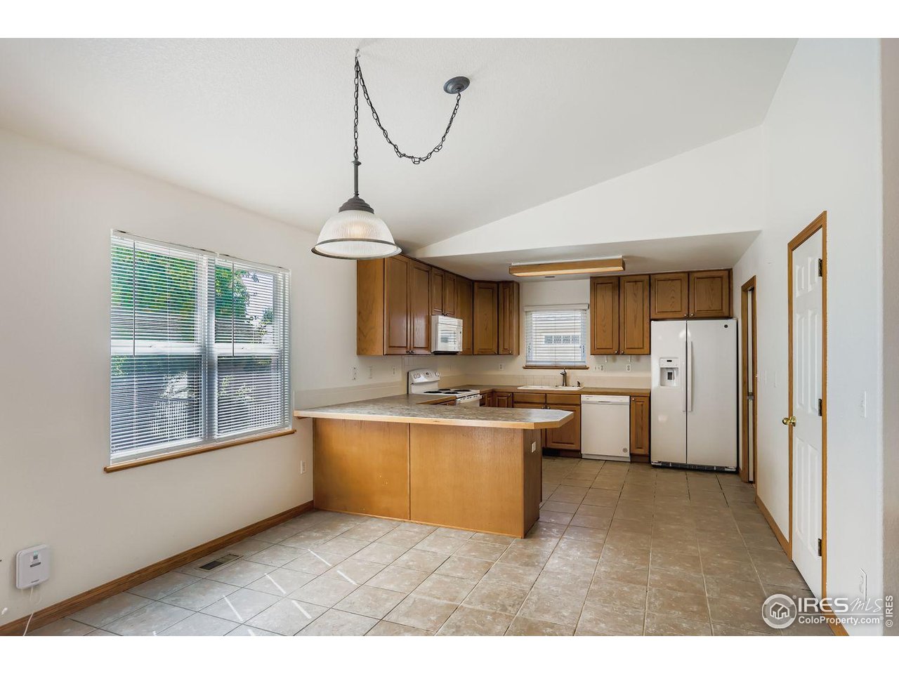 310 Bein Street Berthoud, CO 80513 - Photo 8 of 31 a kitchen with stainless steel appliances granite countertop a sink cabinets and window