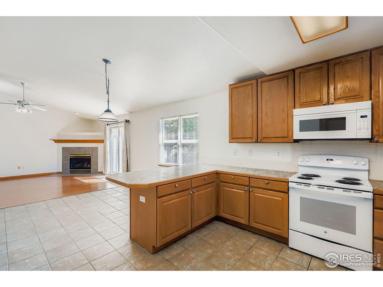 310 Bein Street Berthoud, CO 80513 - Photo 10 of 31 a kitchen with stainless steel appliances granite countertop a stove a sink and a microwave