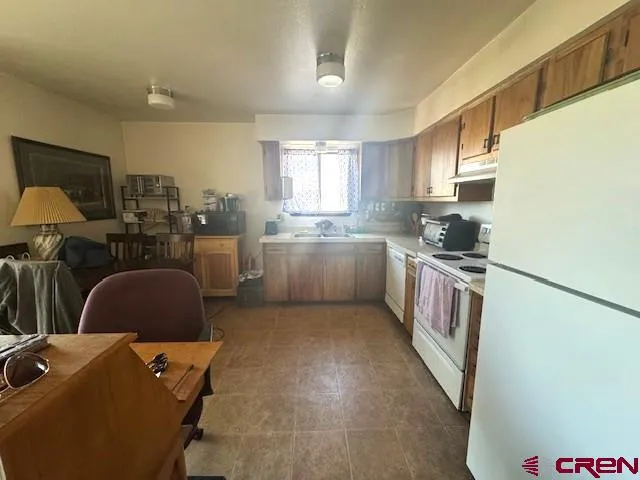 a kitchen with a sink stove and refrigerator