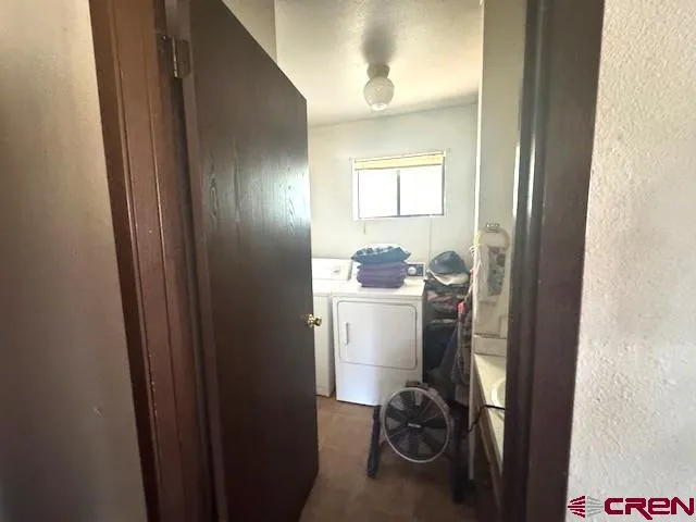 a bedroom with a bed and a dresser in it