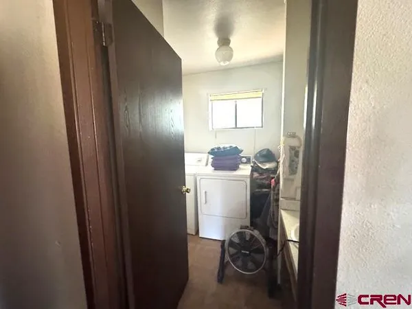 a bedroom with a bed and a dresser in it