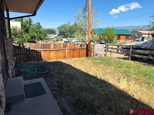 a view of a backyard with sitting area