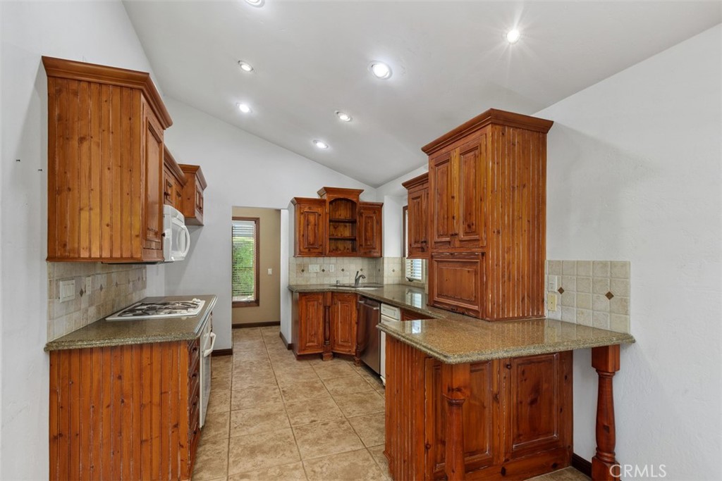 38285 Oaktree Loop Murrieta, CA 92562 - Photo 17 of 39 a kitchen with stainless steel appliances granite countertop a stove a sink dishwasher and a refrigerator