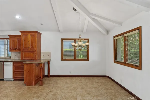 an empty room with fireplace and windows