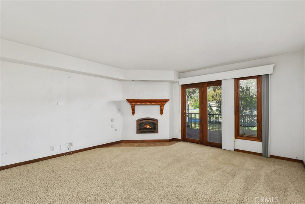 38285 Oaktree Loop Murrieta, CA 92562 - Photo 20 of 39 an empty room with fireplace and windows