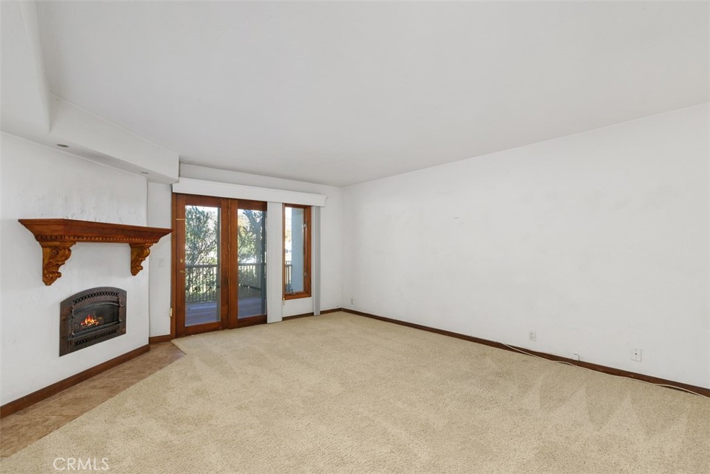 38285 Oaktree Loop Murrieta, CA 92562 - Photo 23 of 39 a view of an empty room with a fireplace and a window