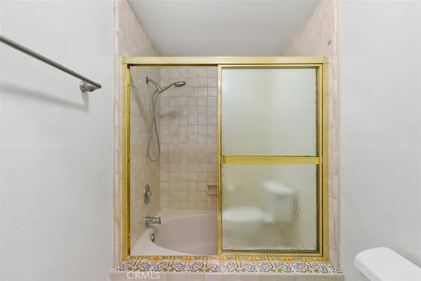 an empty room with a ceiling fan and a window