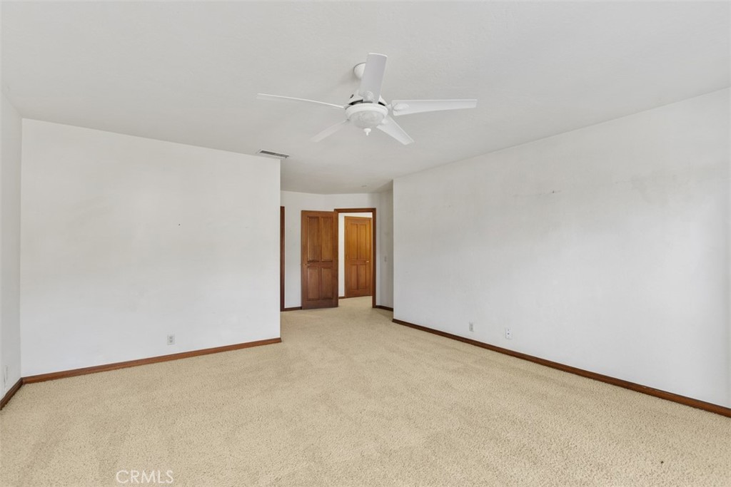 38285 Oaktree Loop Murrieta, CA 92562 - Photo 27 of 39 an empty room with a ceiling fan and a window