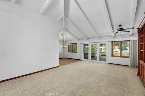 a view of an empty room with a fireplace and a large window