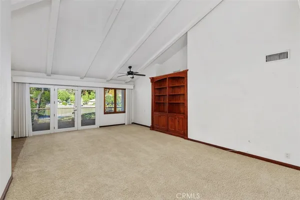 an empty room with closet and natural light