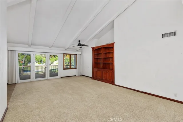 an empty room with closet and natural light