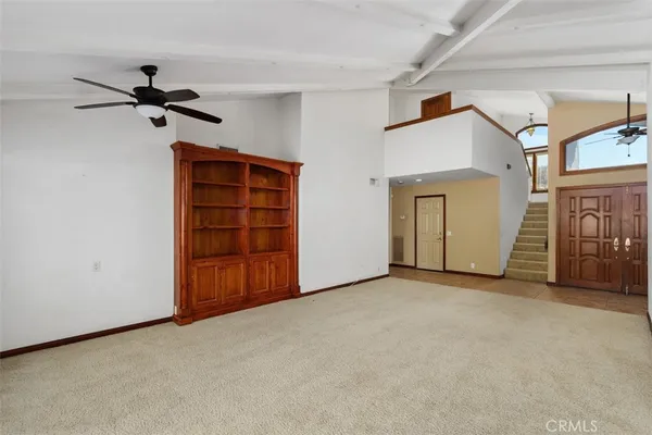 a view of a livingroom with an empty space and a window