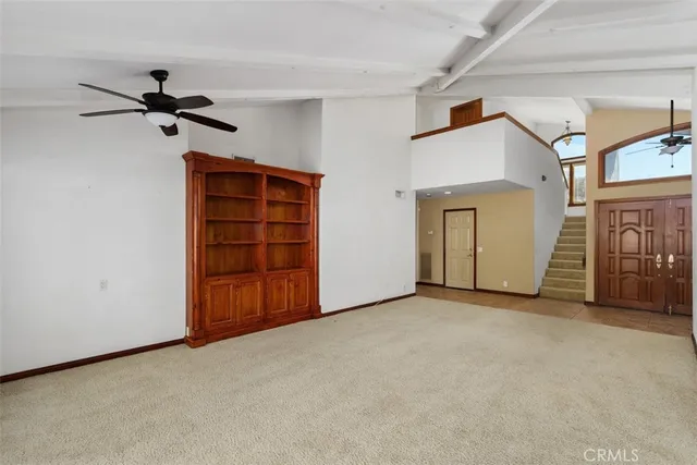 a view of a livingroom with an empty space and a window