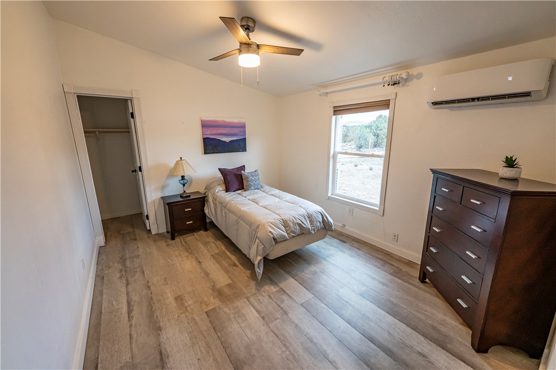 2765 North Silver Springs Road Kingman, AZ 86401 - Photo 27 of 60 a bedroom with a bed and wooden floor