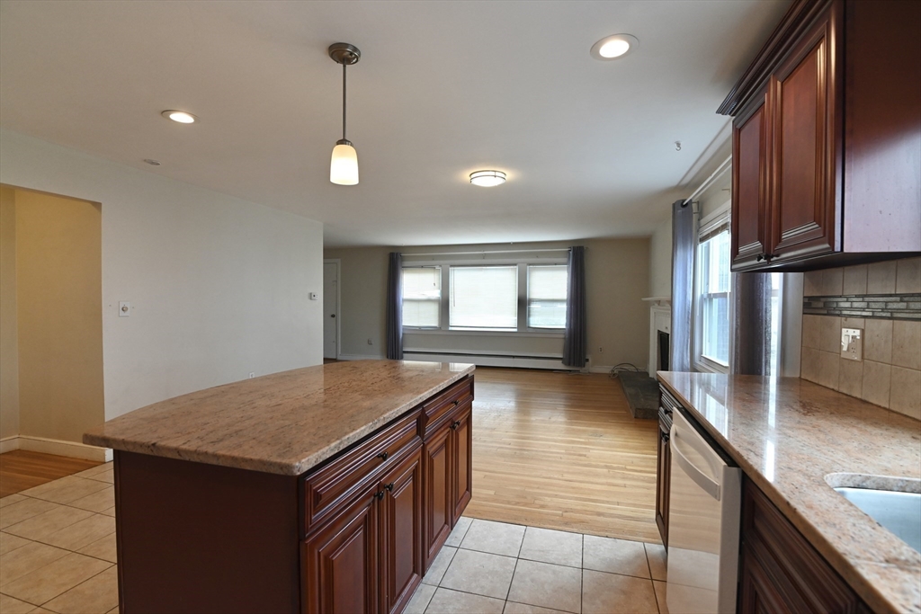 44-42 Farquhar Road, Unit 1 Newton, MA 02460 - Photo 2 of 11 a kitchen with stainless steel appliances granite countertop a sink a oven and a wooden cabinets