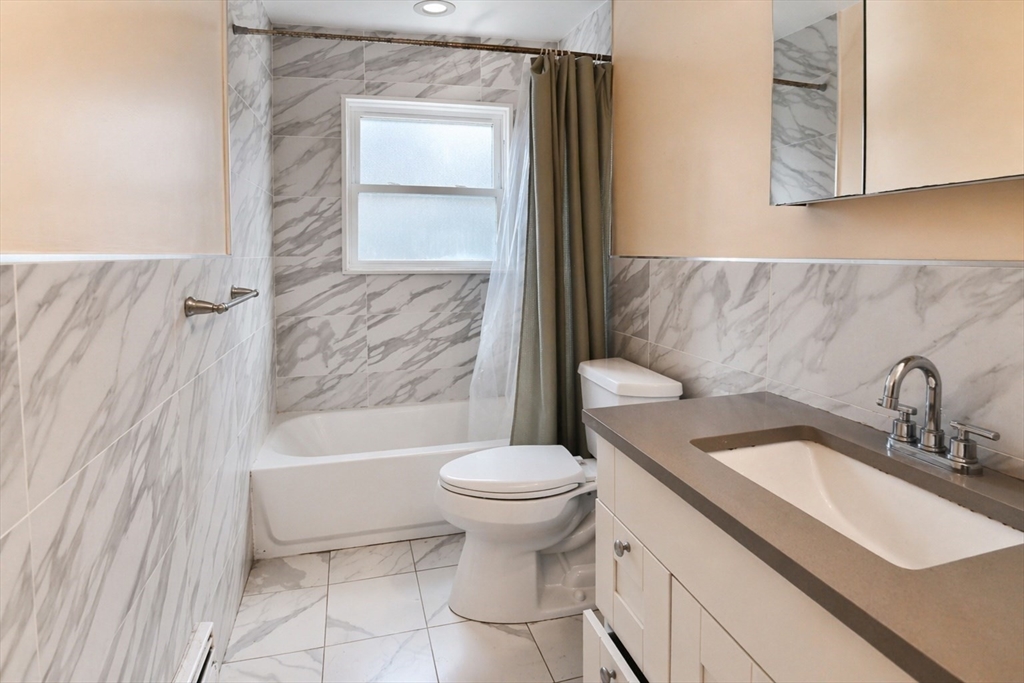 44-42 Farquhar Road, Unit 1 Newton, MA 02460 - Photo 5 of 11 a bathroom with a sink toilet and shower