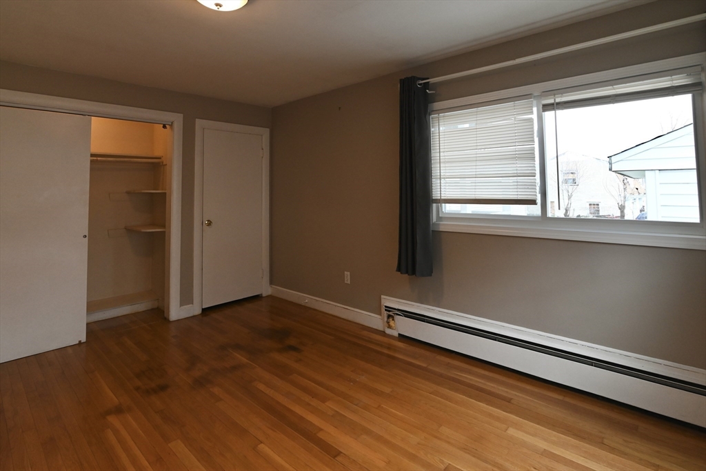 44-42 Farquhar Road, Unit 1 Newton, MA 02460 - Photo 9 of 11 a view of room with window and wooden floor
