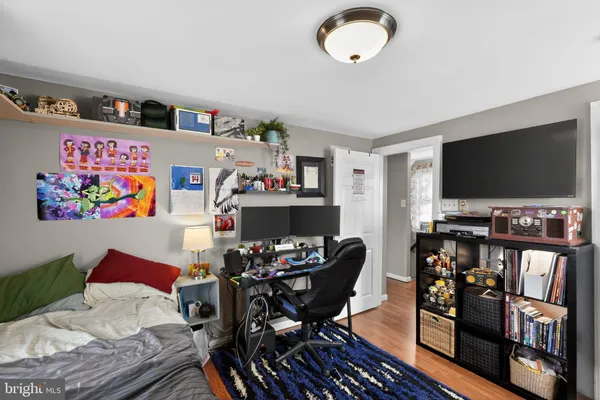 a bedroom with furniture and a flat screen tv