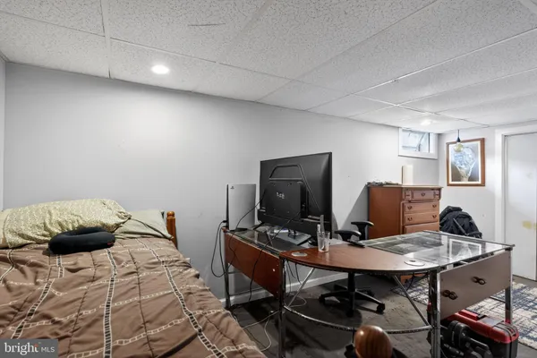 a bedroom with a bed and a desk