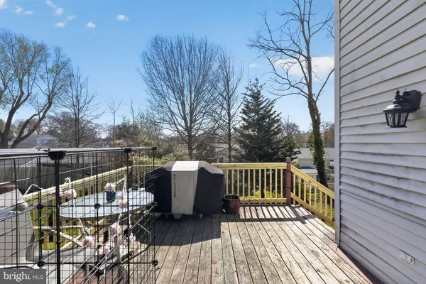 a roof deck view with table and chairs and potted plants