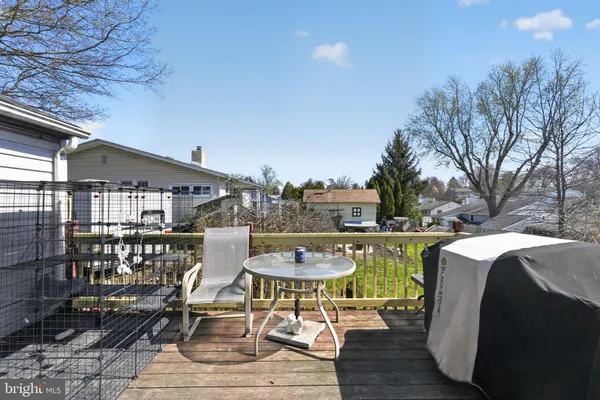 a view of balcony with wooden floor and outdoor seating