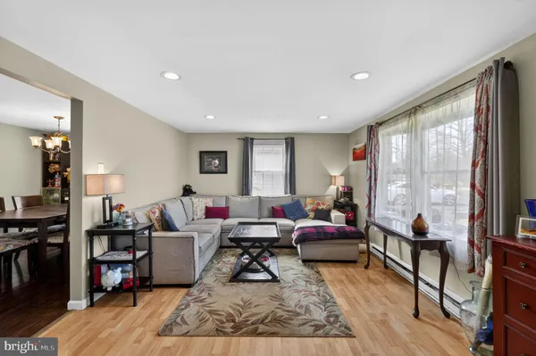 a living room with furniture wooden floor and a large window