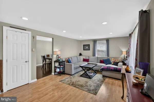 a living room with furniture a window and gym equipment