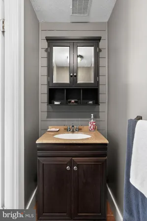 a bathroom with a sink a mirror and vanity